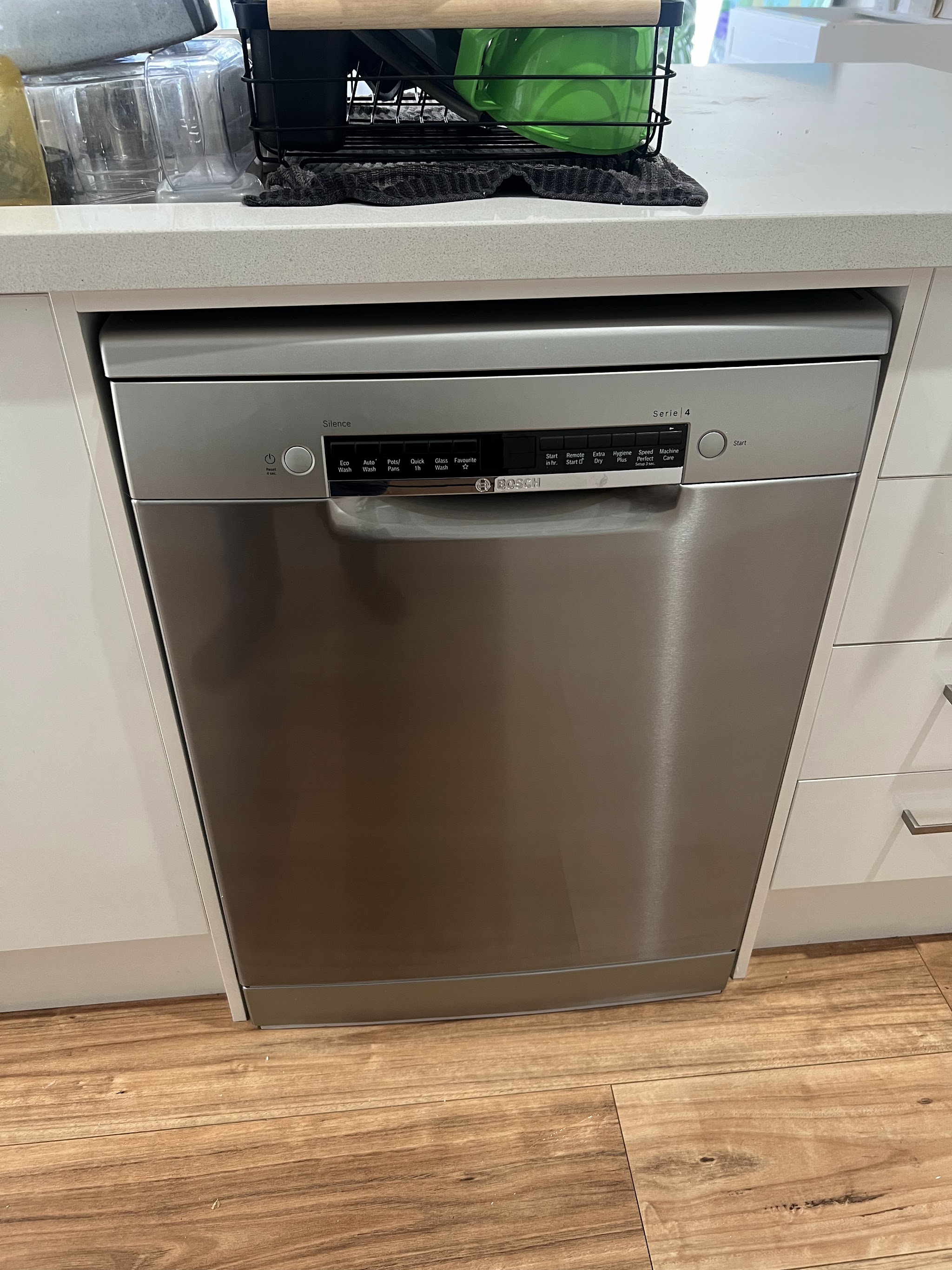 A dishwasher freshly installed under a Nowra kitchen benchtop by Allman Electrical